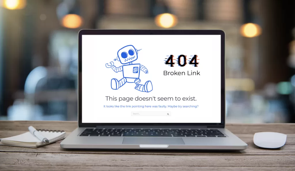 A laptop showing a 404 error with a Broken Robot and Broken Link message