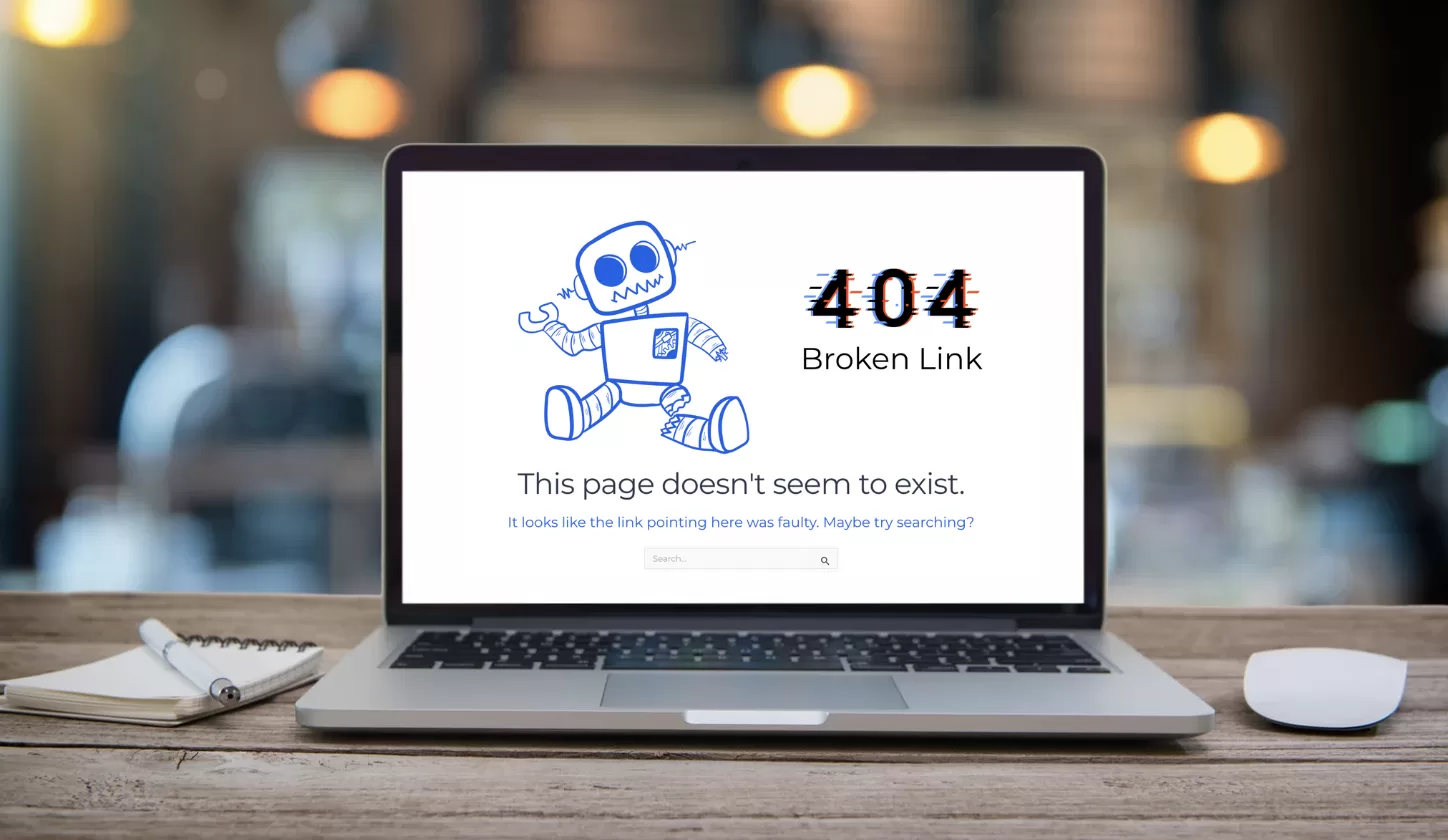 A laptop showing a 404 error with a Broken Robot and Broken Link message